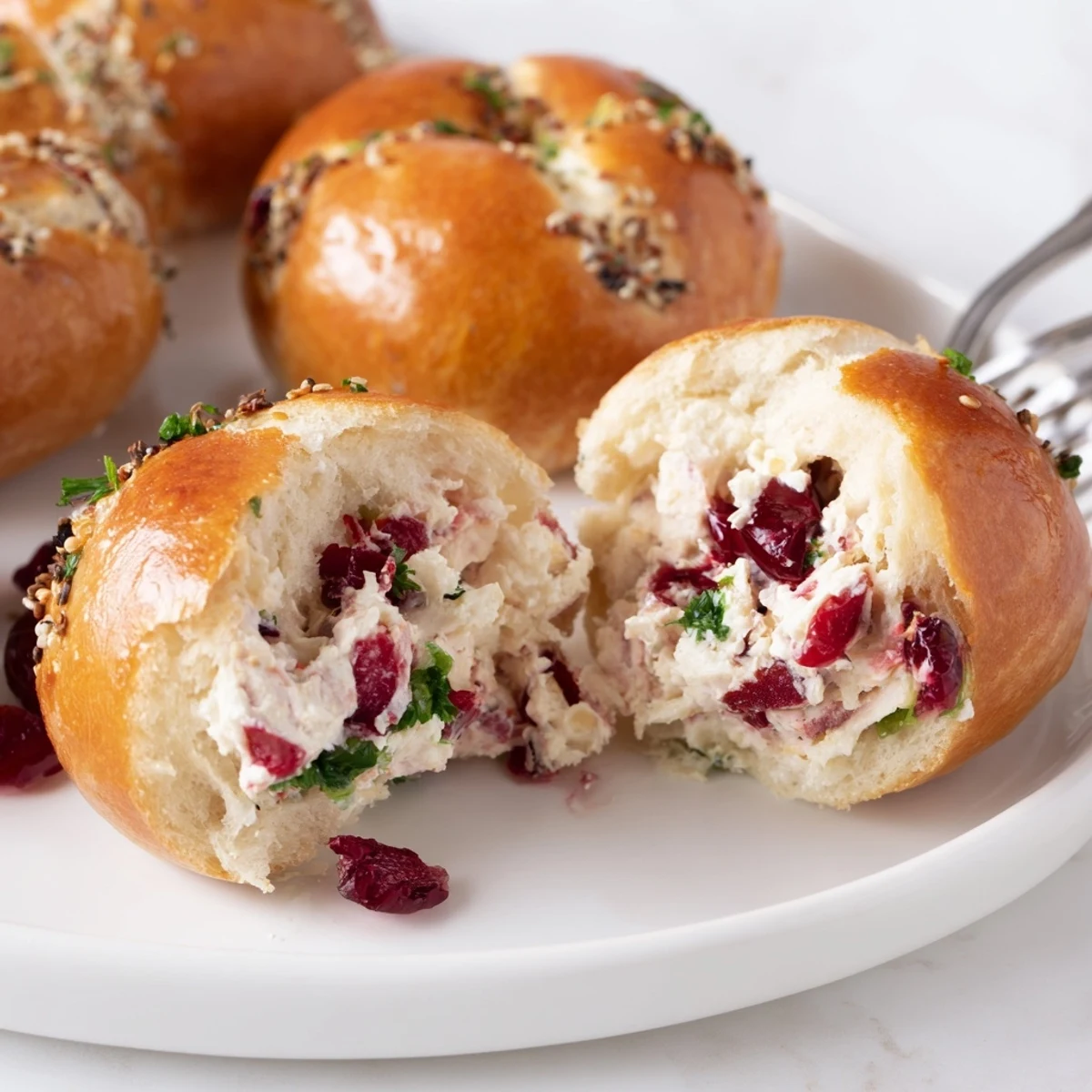 Golden bagel dough encasing tangy cranberry jalapeño dip, perfect for appetizers.  