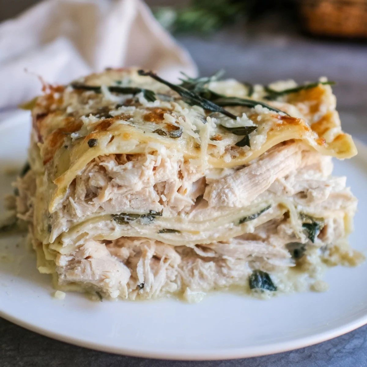 Golden, bubbling Rosemary Chicken Lasagna in a baking dish, ready to be cut and served.