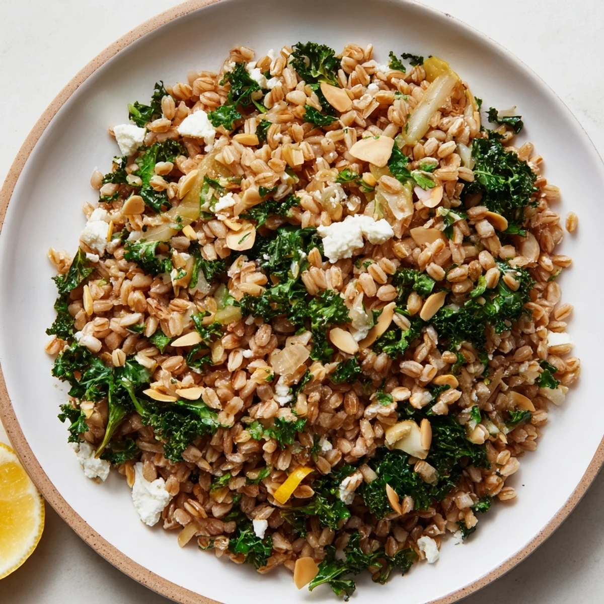 Warm farro and greens pilaf, speckled with bright herbs and toasted almonds, is ready to serve.