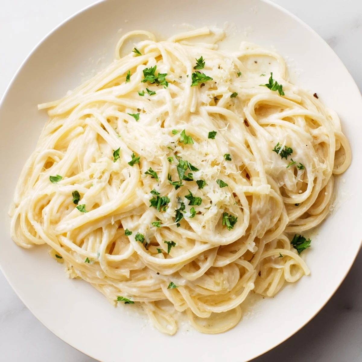 Creamy Three-Cheese Spaghetti, a rich and comforting pasta tossed in a velvety, melted cheese sauce.