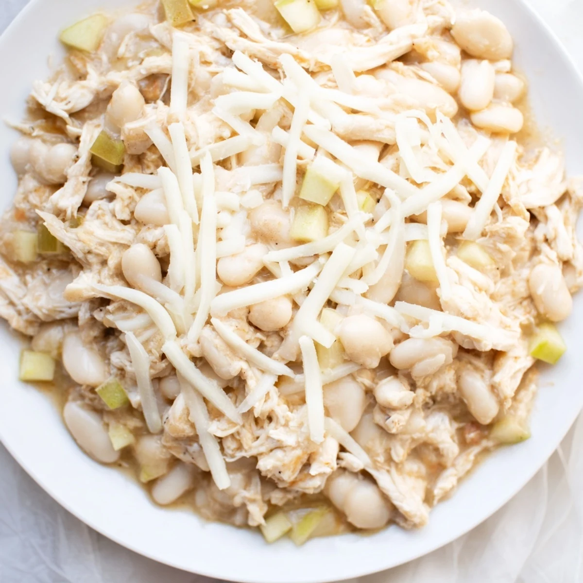 Hearty 35-Minute White Cheddar Apple Chicken Chili: a creamy, savory soup with cooked chicken, white beans.