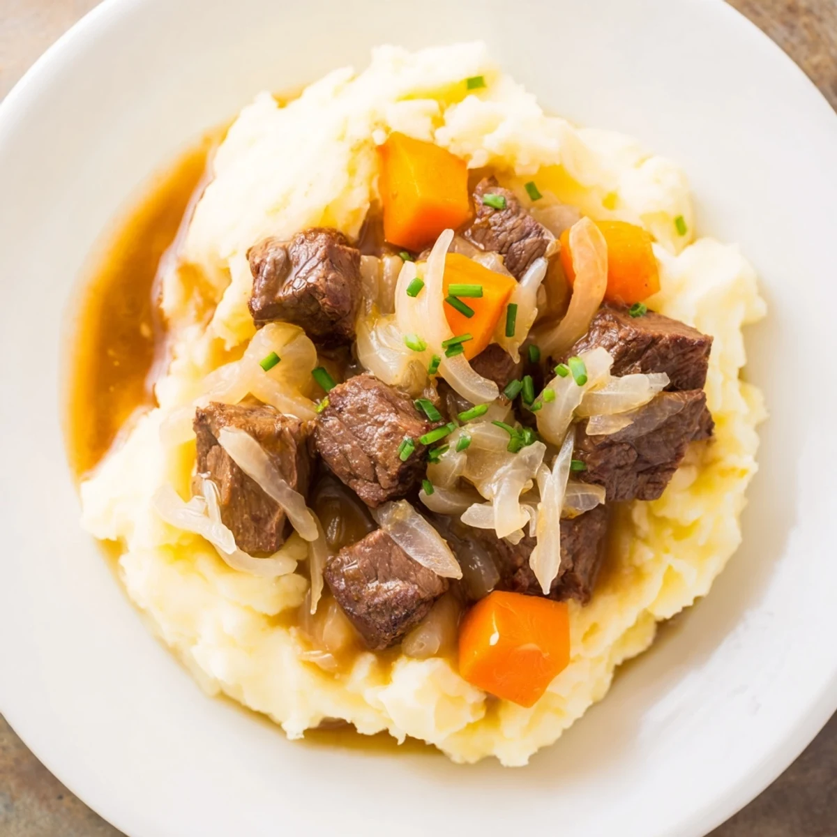 Forkful of juicy beef visible in tender Fall Apple Cider Stew, ready to pair with cheesy mash.