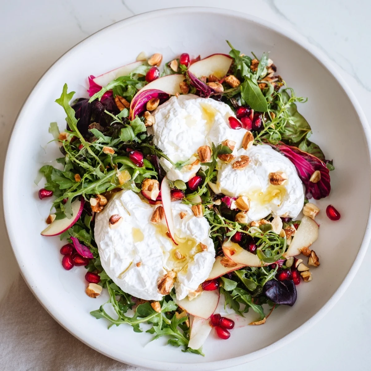 Freshly tossed Spiced Honey and Date Goat Cheese Salad, drizzled with warm honey for a flavorful meal.