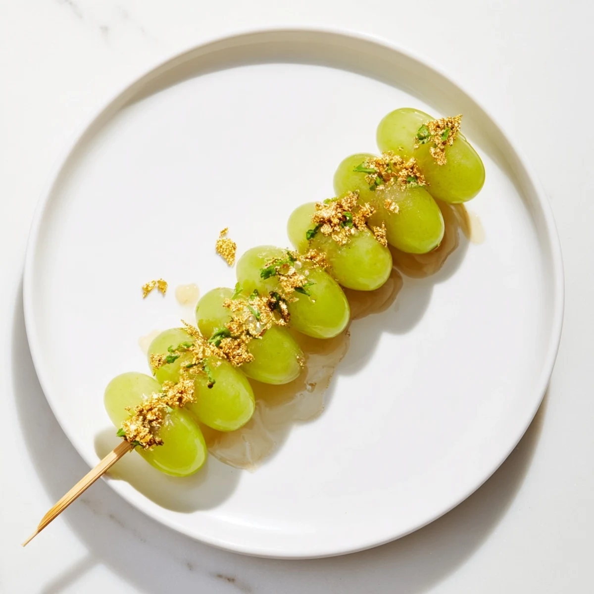 Twelve vibrant green grapes skewered elegantly for these Grapes of Luck Countdown, a gluten-free dessert option.