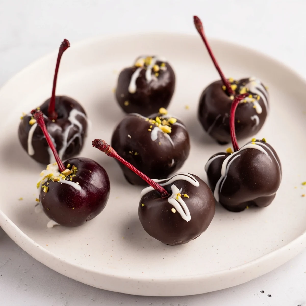 A dazzling pyramid of rich, dark chocolate-covered cherry dessert bites, ready to enjoy.