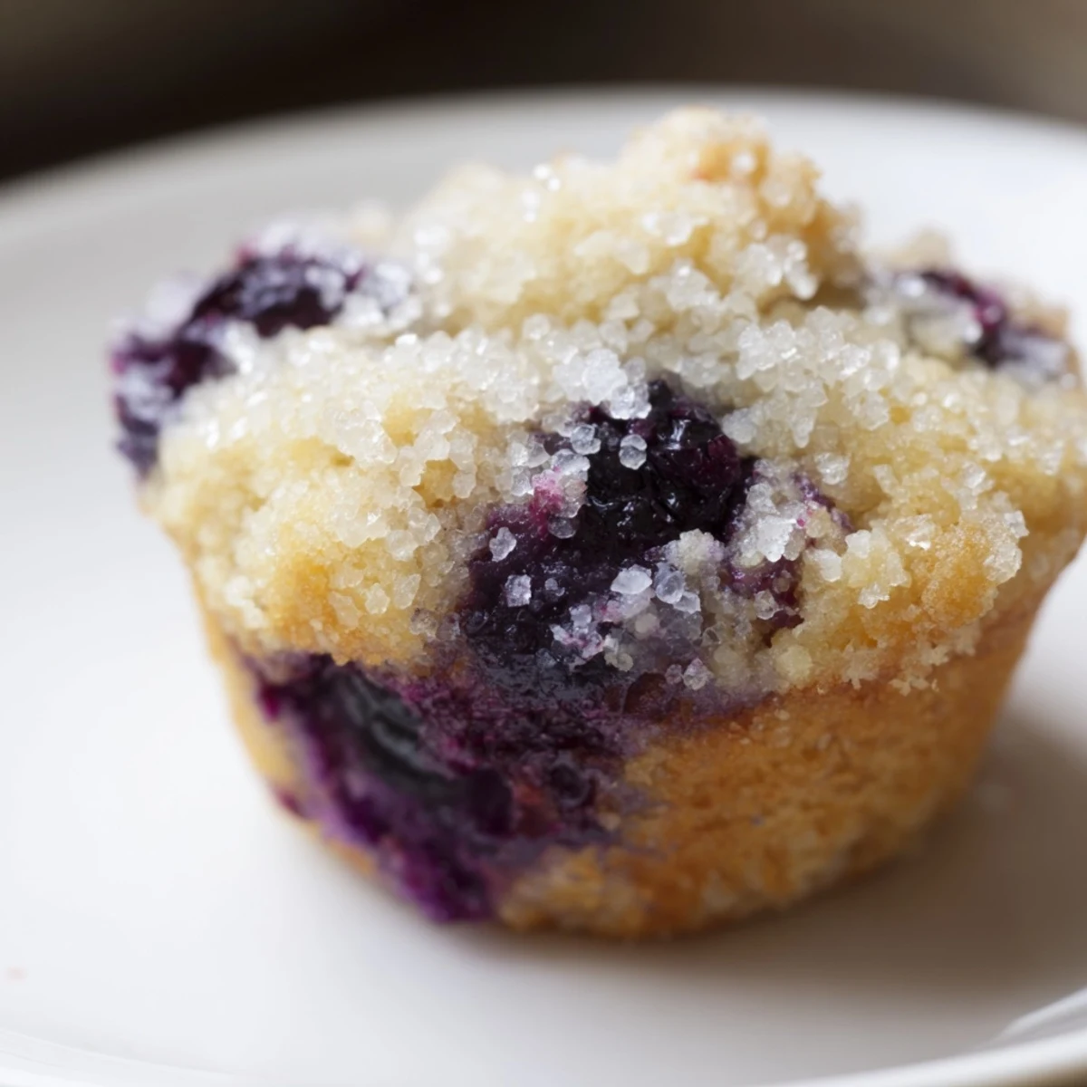 Warm, golden mini blueberry muffins fresh from the oven, offering a sweet, comforting bite.