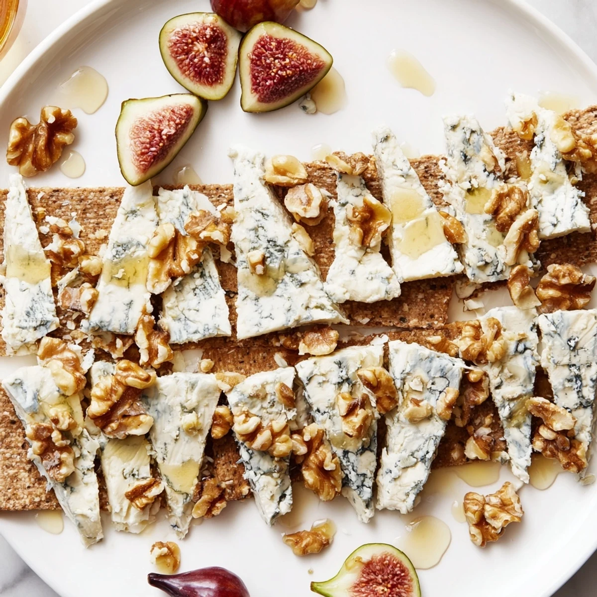 A glorious Blue Ridge Mountain cheese platter with blue cheeses shaped like peaks, served on crackers.