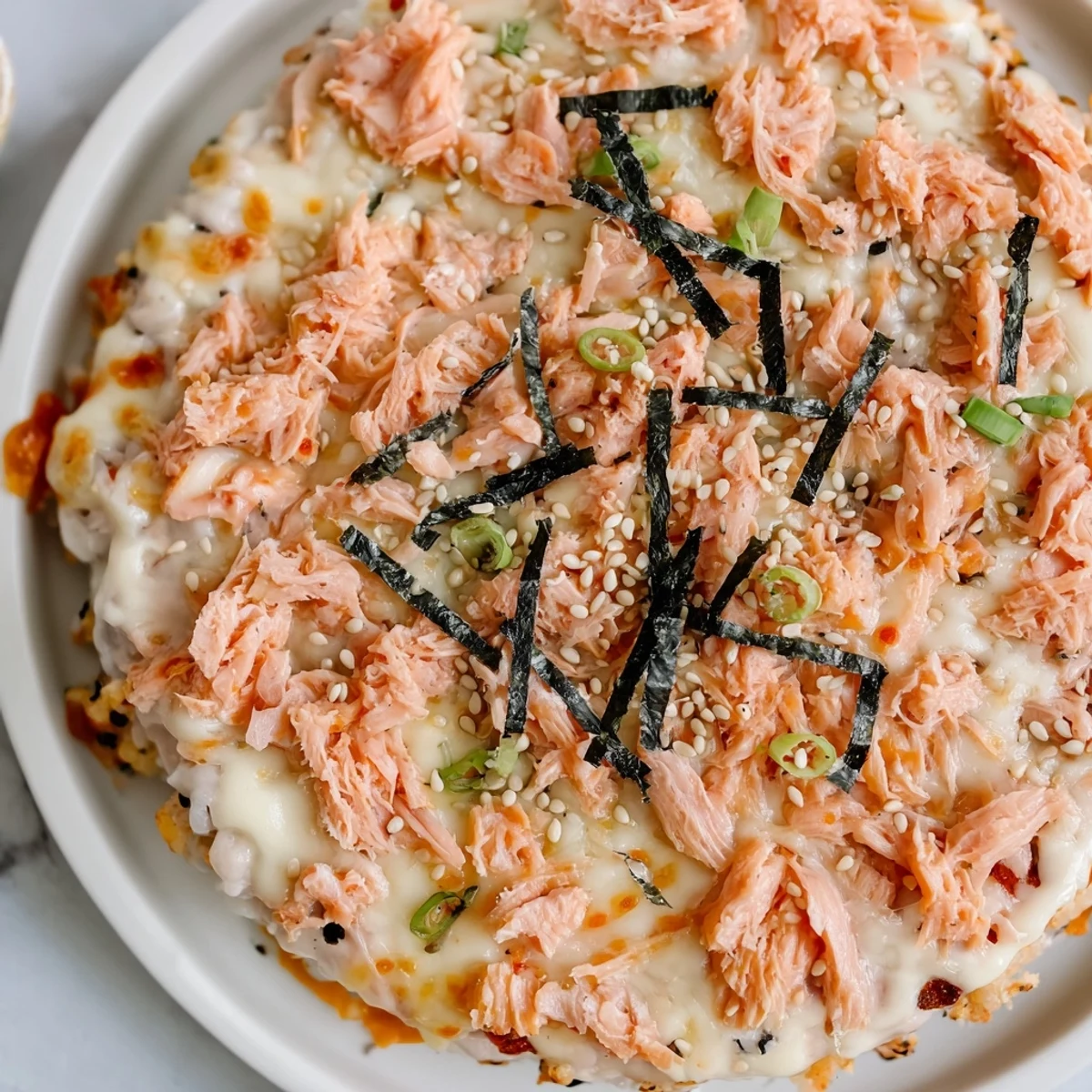 Golden, bubbly Creamy Salmon Sushi Bake, a deconstructed sushi dish with savory salmon and toppings.
