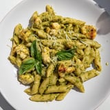 Golden chicken and al dente penne pasta coated in creamy pesto – ready for delicious eating.
