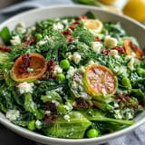 Bright lemon vinaigrette spring salad with radishes and peas in a white serving bowl, showcasing crisp vegetables and vibrant green hues.