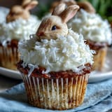 Fluffy coconut cupcakes topped with marshmallows and shredded coconut for a festive Easter bunny tail look.  