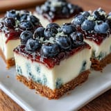 Vibrant no-bake lemon blueberry cheesecake bars, a refreshing summer dessert.