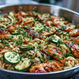 Tender orzo pasta with seared chicken and fresh zucchini, zesty with lemon.