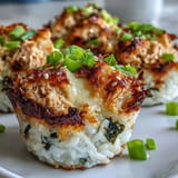 Creamy tuna filling nestled in nori cups and baked for a delightful bite.
