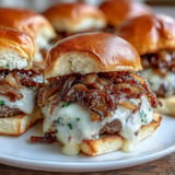 Juicy French onion smash burger sliders with caramelized onions on soft buns.