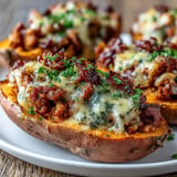 Baked sweet potatoes filled with tender apple and sausage, a perfect comforting meal.