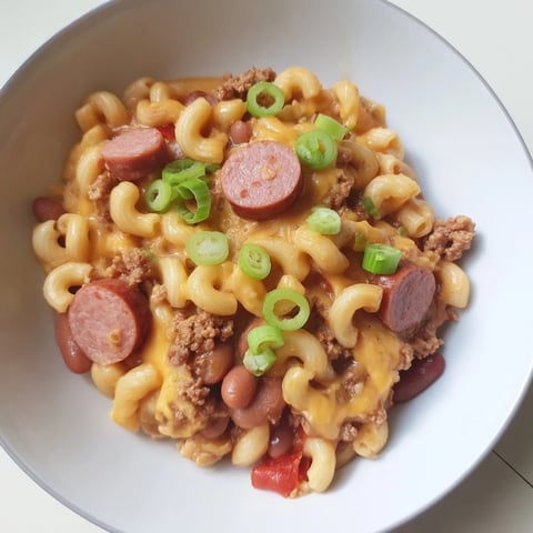 Creamy Chili Cheese Dog Mac & Cheese, bubbling in a baking dish, smells of savory chili and melted cheese.