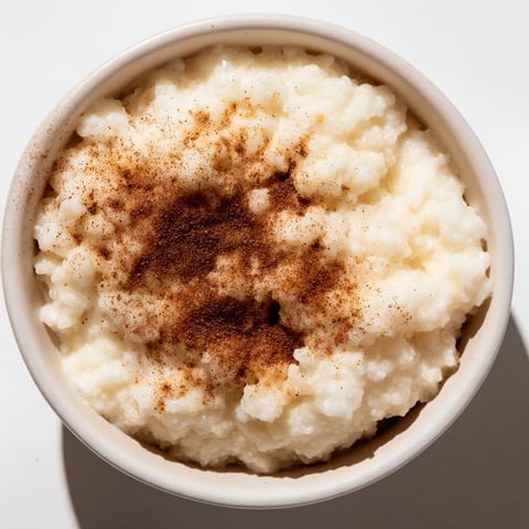Creamy rice pudding with leftover rice, swirled with cinnamon, perfect for a cozy dessert any time.