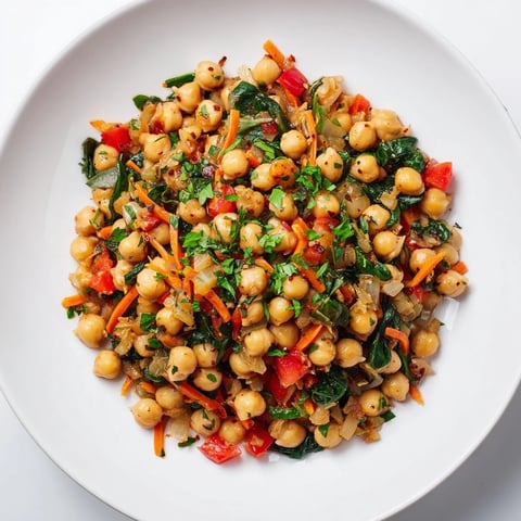 Vibrant Vegetarian Chickpea & Spinach Skillet, served in a skillet, with fresh herbs and zesty lemon.