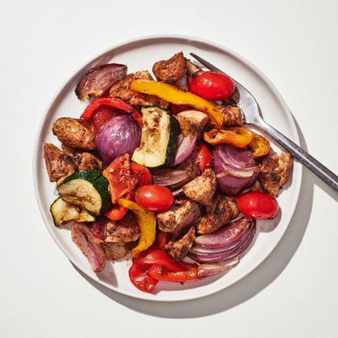 Golden-brown Sheet Pan Chicken Shawarma, with roasted vegetables and a fragrant spice aroma.
