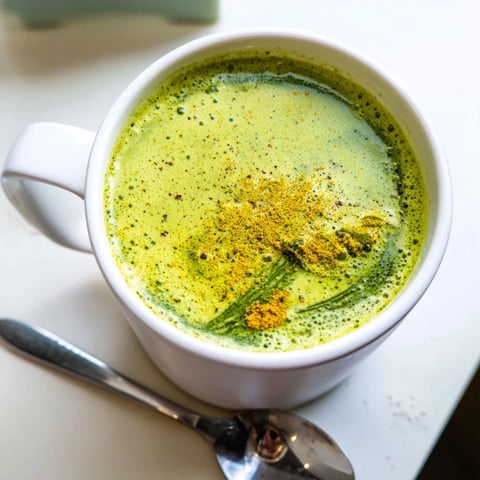 Steaming Coconut Ginger Matcha Winter Immunity Latte, a vibrant green beverage, ready for a cozy winter evening.