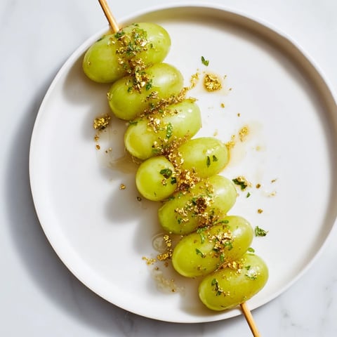 Sweet Grapes of Luck Countdown Skewers glistening with optional honey and festive edible sprinkles.