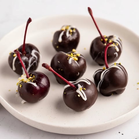 A dazzling pyramid of rich, dark chocolate-covered cherry dessert bites, ready to enjoy.