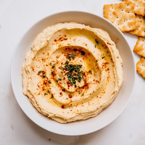 The Sandstone Canyon appetizer: creamy hummus layers with beige crackers, a beautiful Mediterranean-inspired dish.