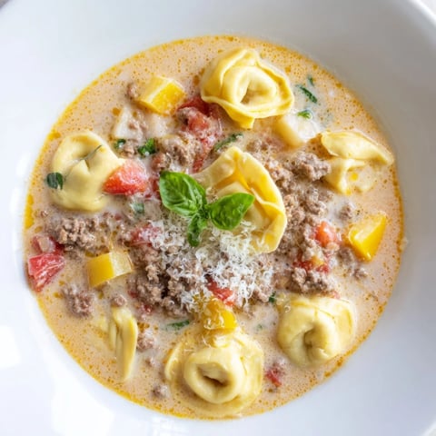Steaming bowl of Tortellini Beef Soup, brimming with tender tortellini and flavorful broth.