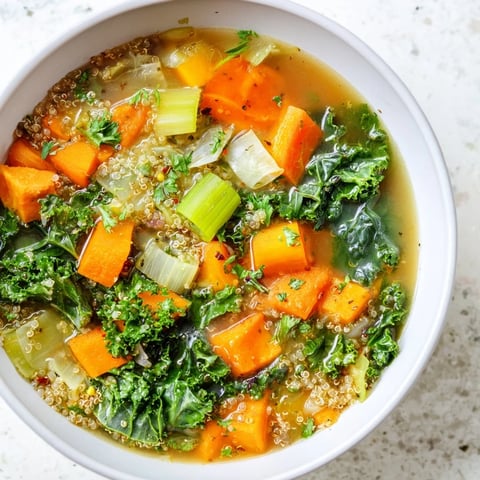 Steaming bowl of Nourishing Winter Veggie Soup, vibrant colors showcased with fresh parsley garnish.