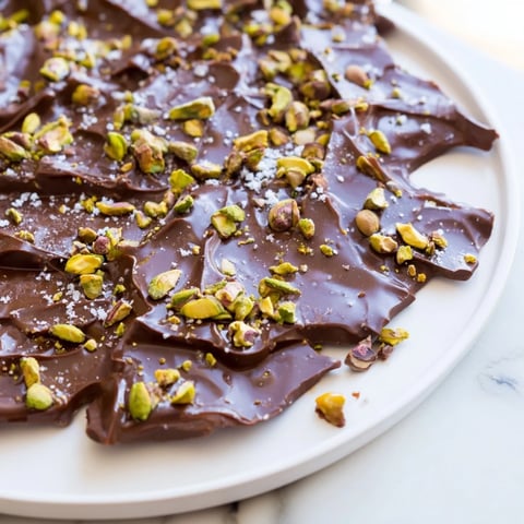 Close-up view of Pistachio Salted Caramel Bark, showcasing the beautiful layers of chocolate, caramel, and nuts.