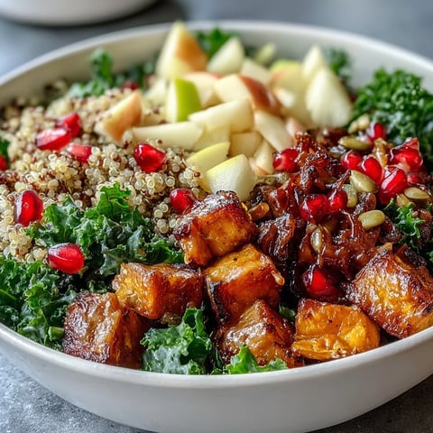 Vibrant Kale Harvest Grain Bowl with roasted sweet potatoes, pomegranate, and tangy dressing