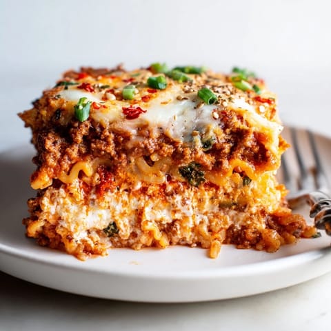 Delicious Spicy Ramen Lasagna baked to perfection with melted mozzarella and a spicy kick.  