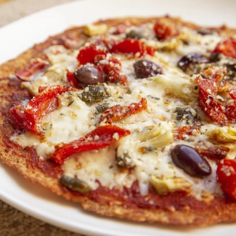 Freshly baked tortilla pizza, featuring a colorful assortment of pantry toppings and bubbling cheese.