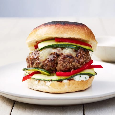 Close-up of a juicy Fire & Ice Burger, showing the spicy burger patty and fresh colorful toppings.