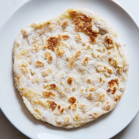 A stack of delicious cottage cheese flatbread, slightly blistered and ready for your favorite toppings.