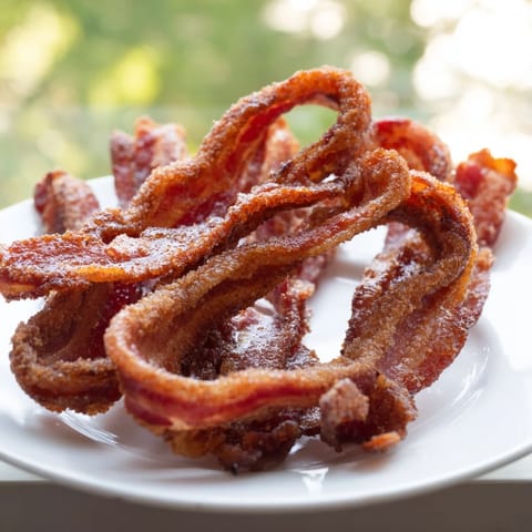 Close-up of golden-brown Spiced Bacon Twists: a delicious American appetizer, ready to eat.