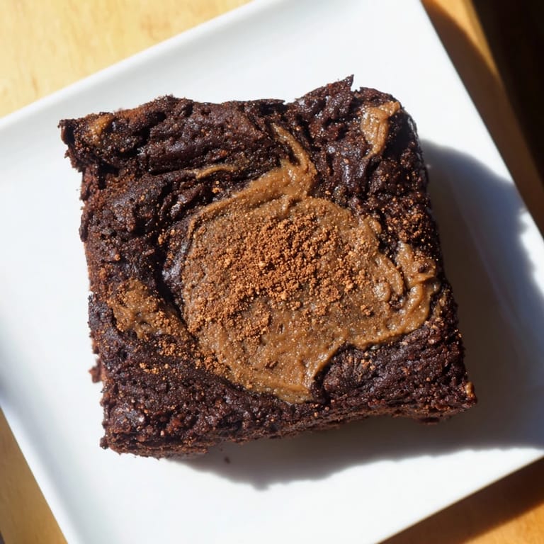 Warm, dark brown Pumpkin Workout Brownies, cut into squares, ready to be enjoyed after a workout!