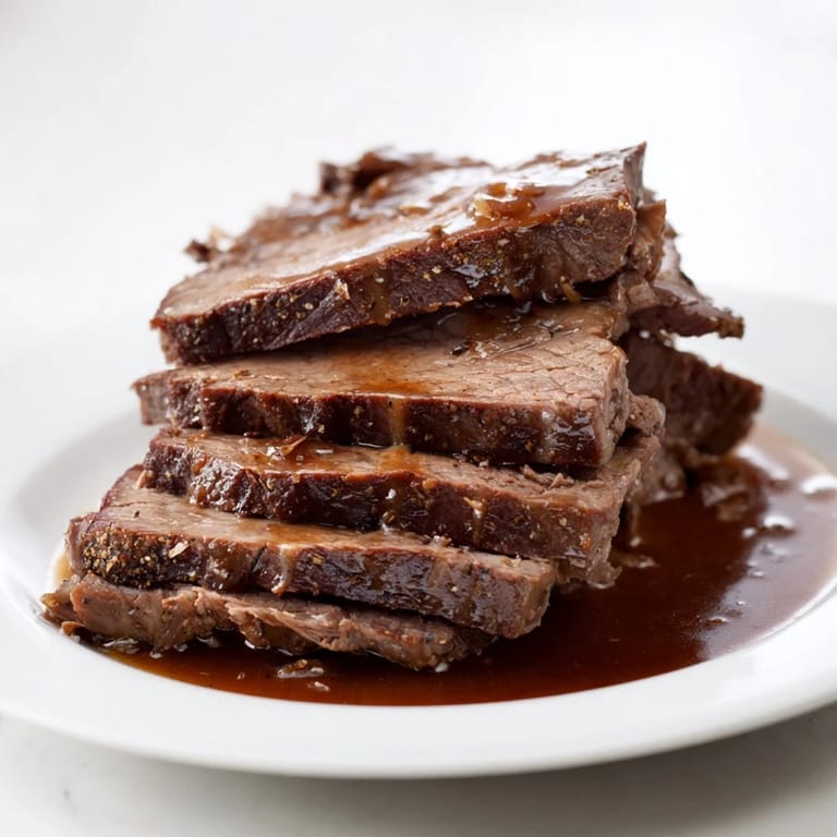 A steaming Dutch oven reveals perfectly cooked Budget Holiday Chuck Roast for a simple holiday meal.