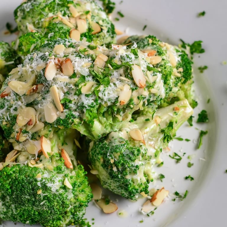 Savory Garlic Parmesan Broccoli Salad tossed in creamy dressing, served as a vegetarian side or light lunch with grated Parmesan.