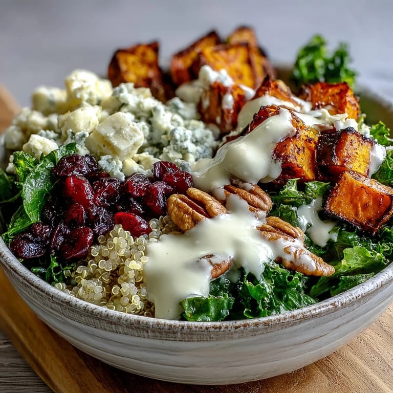 Golden roasted sweet potatoes and fluffy quinoa top this nutritious Harvest Kale Quinoa Bowl, drizzled with zesty dressing.