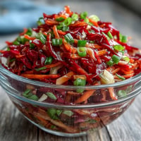 Vibrant red cabbage slaw, a crunchy, fresh side dish, ideal for summer picnics.