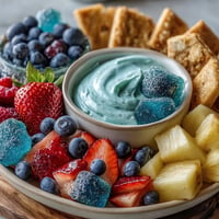 Vibrant Cool Blue Lemonade Dessert Board loaded with sweet cookies and fresh fruit.